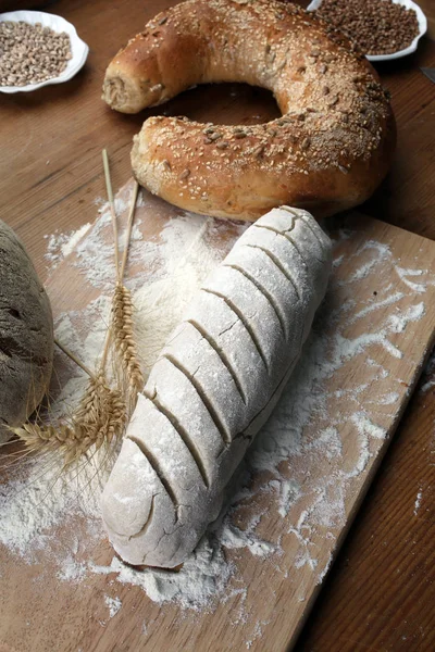 Baking bread. Dough on wooden table with flour.