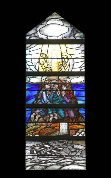 God begins salvation in this world through His Son Jesus Christ, stained glass window by Sieger Koder in St John church in Piflas, Germany