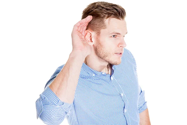 Man with impaired hearing struggling to hear frowning as he holds his hand to his ear in an attempt to improve acoustics — Stock Photo, Image