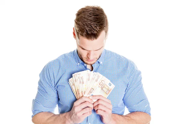 Porträtt av framgångsrik ung man hålla pengar euro räkningar i hand, isolerade på vit bakgrund. Finacial koncept — Stockfoto