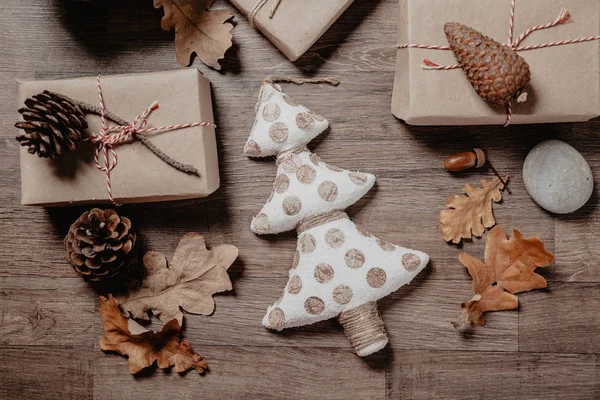 Small white Christmas tree with Christmas or New year gifts. Holiday decor concept. Toned picture. Top View. Flat lay. — Stock Photo, Image