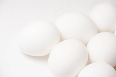 white plain eggs laying on the white background