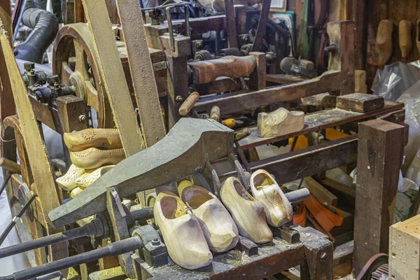 Manufacturing wooden shoes Klompen (clogs) in Holland. National traditional Dutch wooden shoes. Clog and Klomp Workshop. machine and part blanks.