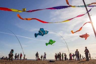 Saint Petersburg, Rusya - 31 Ağustos 2019. İnsanlar etrafta dolanıyor, renkli kurdeleler ve uçurtma figürleri direkte asılı ve mavi gökyüzü arka planında uçuyor, uçurtma festivali