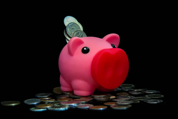 粉红的储蓄罐里装满了黑色背景的硬币 投资储蓄的概念 赚钱呀 — 图库照片