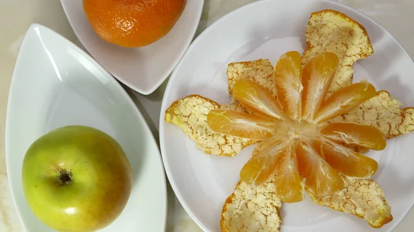Still life with peeled mandarin and apple — Stock Photo, Image