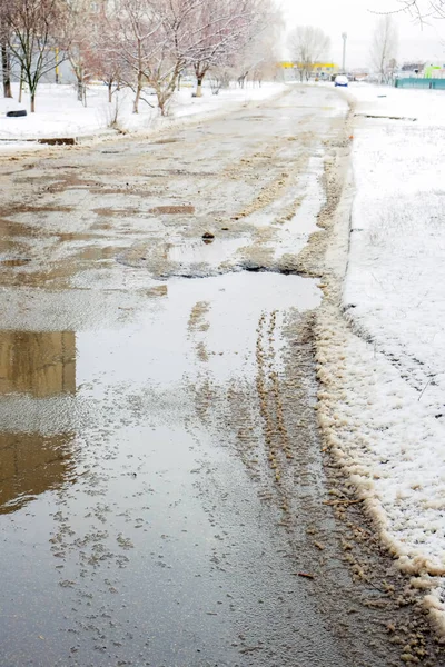 Paved road covered with melting snow