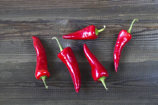 Cayenne chilli peppers on wooden background — Stock Photo, Image