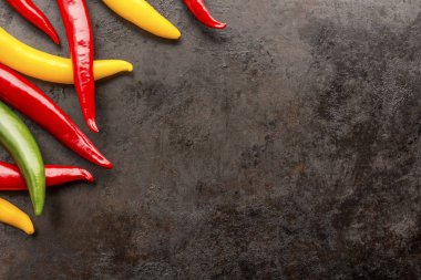 chilli peppers on rusty metal background