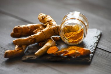 Zerdeçal tozu ve taze zerdeçal kökü.