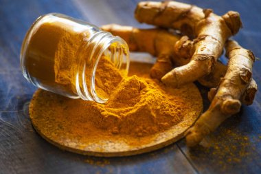 Zerdeçal tozu ve taze zerdeçal kökü.