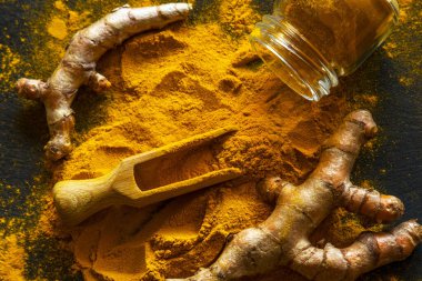 Zerdeçal tozu ve taze zerdeçal kökü.