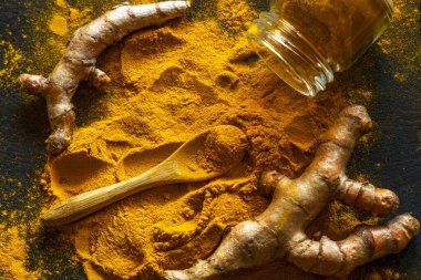 Zerdeçal tozu ve taze zerdeçal kökü.