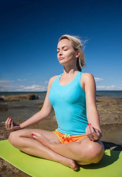 Unga kaukasiska fitness kvinna utövar yoga — Stockfoto