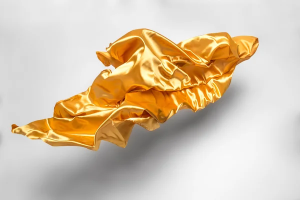 Goldener fliegender Stoff — Stockfoto
