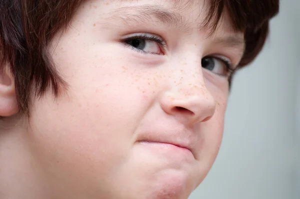 Close up of a young boy looking to get into trouble. — Stock Photo, Image