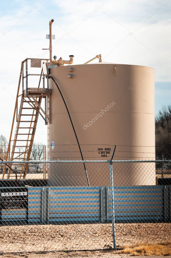 A crude oil storage tank to collect oil as it is pumped.