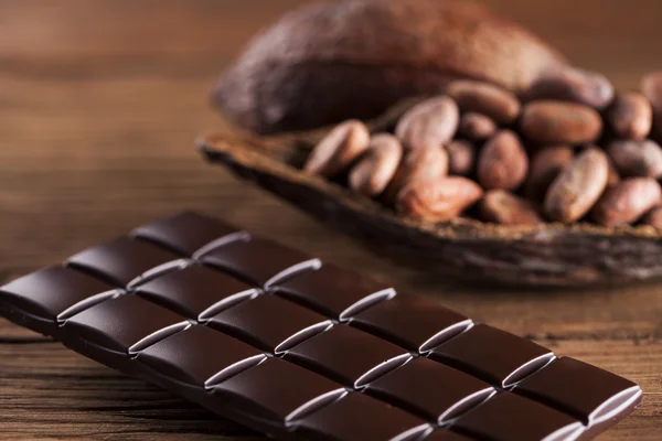 Chocolade repen met cacao bonen en poeder — Stockfoto