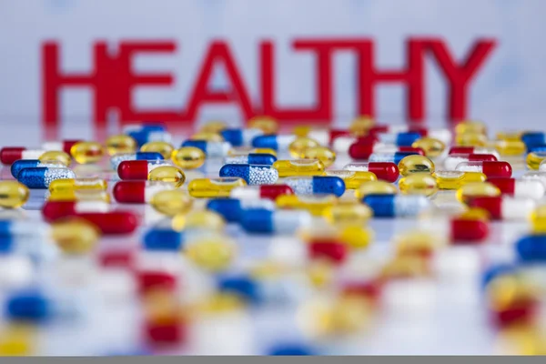 Gezonde achtergrond met pillen, tabletten en Capsules — Stockfoto