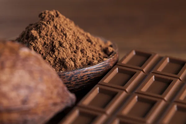 Chocolate bars, cacao beans and powder — Stock Photo, Image