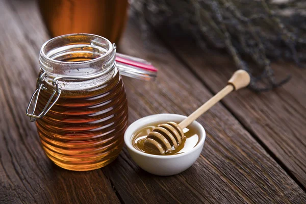 Fresh honey on wooden table — Stock Photo, Image