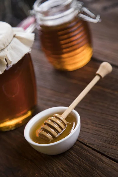 Fresh honey on wooden table — Stock Photo, Image