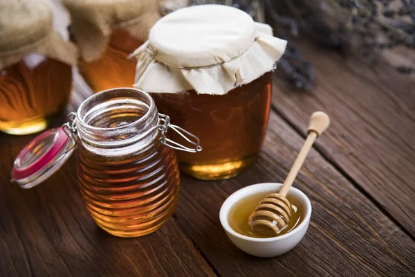 Fresh honey on wooden table — Stock Photo, Image