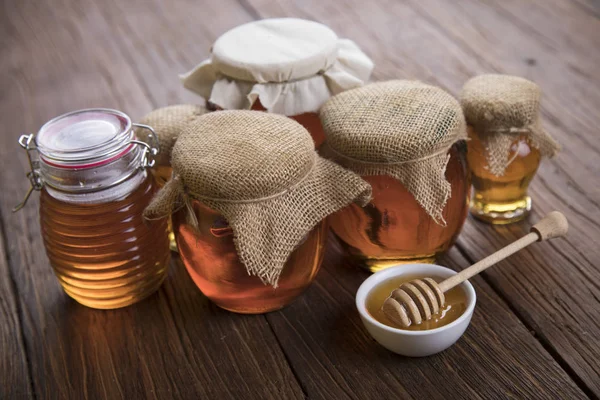 Fresh honey on wooden table — Stock Photo, Image