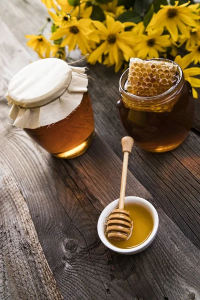 Fresh honey on wooden table — Stock Photo, Image