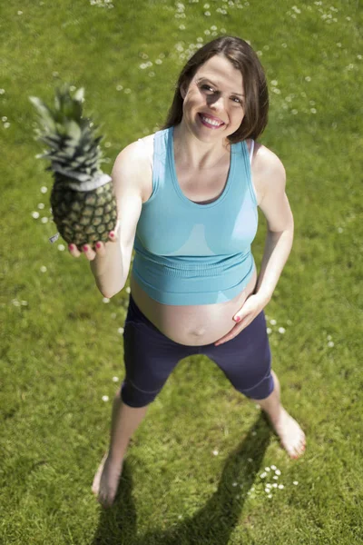 Pregnant woman doing fitness exercise Stock Photo