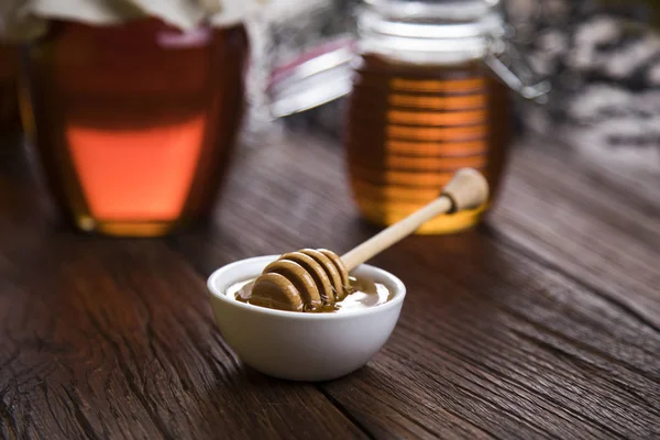 Fresh honey on wooden table — Stock Photo, Image