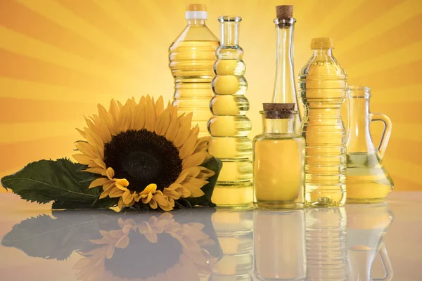 Bottles of sunflower oil with flower — Stock Photo, Image