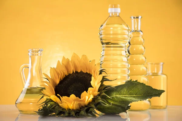 Bottles of sunflower oil with flower — Stock Photo, Image