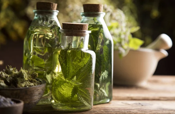 Oil and Natural medicine, wooden table background — Stock Photo, Image