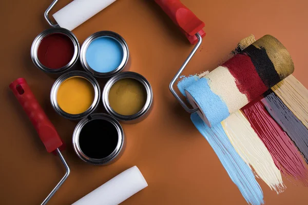 Metal tin cans with color paint and paintbrush