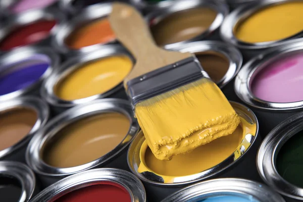 Tin cans with paint, brushes and bright palette of colors — Stock Photo, Image