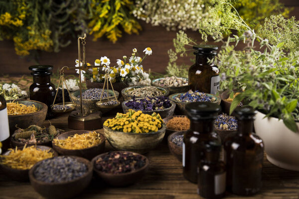 Homeopathy, herbal medicine on wooden table
