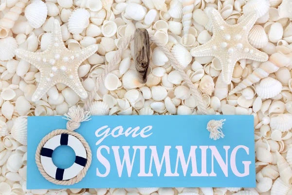 Gone Swimming Sign on Seashells — Stock Photo, Image