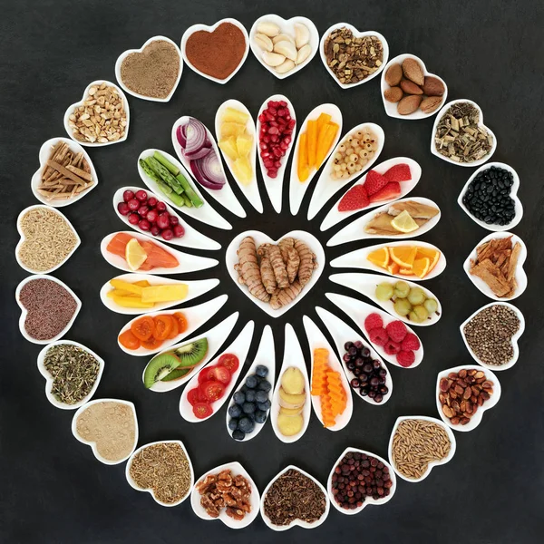 Health food for a healthy heart with vegetables, fruit, fish, nuts