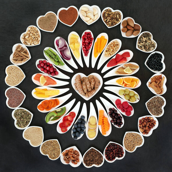 Health food for a healthy heart with vegetables, fruit, fish, nuts, seeds, supplement powders, pulses, cereals, spices and herbs used in herbal medicine. High in omega 3 fatty acid, anthocyanins, antioxidants and vitamins.