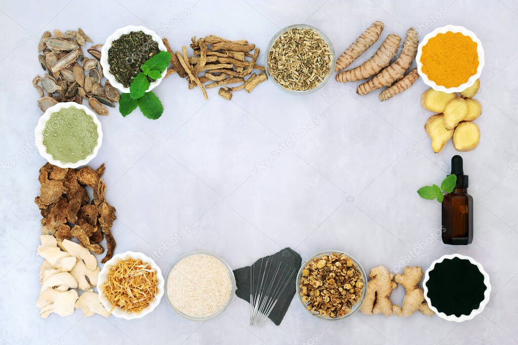Health food to treat irritable bowel syndrome with herbs used in chinese herbal medicine, acupuncture needles, essential oil & dietary supplement powders & vitamins forming a  border. Flat lay.