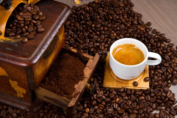 Roasted coffee beans with cup of coffee — Stock Photo, Image