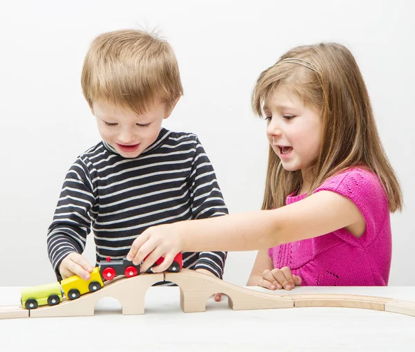 Brother and sister playing with train — Stock Photo, Image