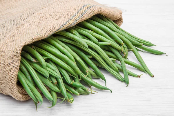 Canvas sack full of green beans — Stock Photo, Image