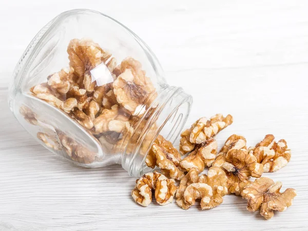 Jar with  hazelnuts on white wood background — Stock Photo, Image