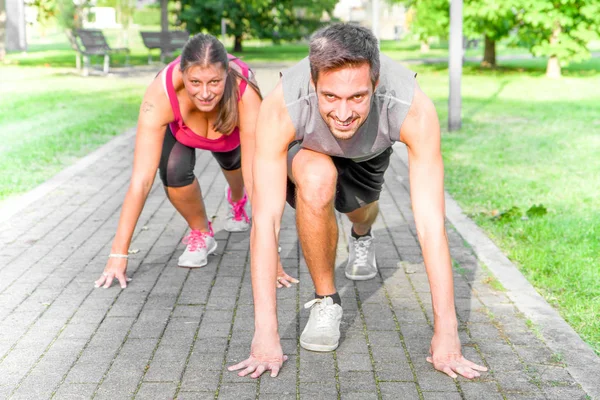Handsome Athletic Man and woman in Running Start Position — Stock Photo, Image
