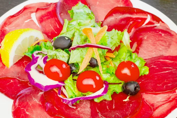 Dish with bersaola and mixed salad — Stock Photo, Image