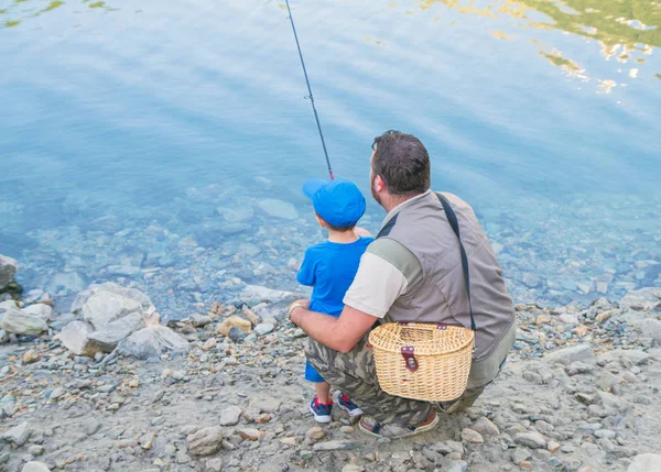 Dad and son are fishing together — Stock Photo, Image