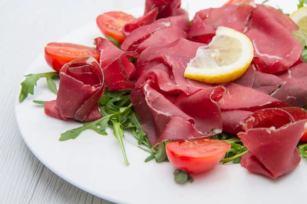 Dish of bresaola and aragula — Stock Photo, Image