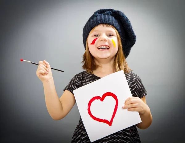 Meisje van de schilder met een drwan hart geïsoleerd op grijs — Stockfoto